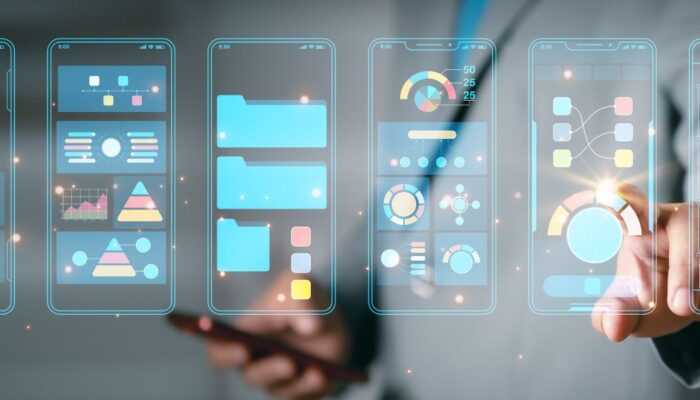 Person interacting with virtual mobile app interface prototypes displaying charts, graphs, and UI elements for app development.